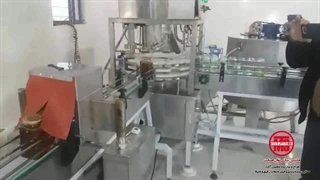 دستگاه پرکن عسل توان صنعت | دستگاه پرکن شیشه عسل | دستگاه پرکن و دربند عسل | خط بسته بندی عسل | 09152000050